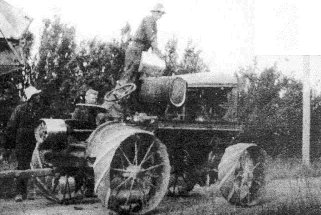 RH McCallum refueling Fitch tractor 1927